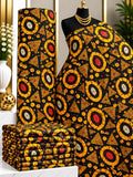 Amber Orbit African print cotton fabric in gold, orange and black, featuring concentric rings with dotted geometric accents; shown draped and folded.