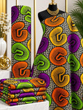 Paisley Carnival African print cotton fabric in purple, orange, green, yellow and black, featuring large rounded paisley-like shapes with fine dotted outlines; shown draped and folded.