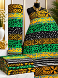 Emerald Bands African print cotton fabric in green, yellow and black, featuring broad horizontal bands of varied angular geometric motifs; shown draped and folded.