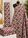 Burgundy Lacework African print cotton fabric in burgundy and cream, featuring densely repeated floral medallions and curling ornamental forms; shown draped and folded.