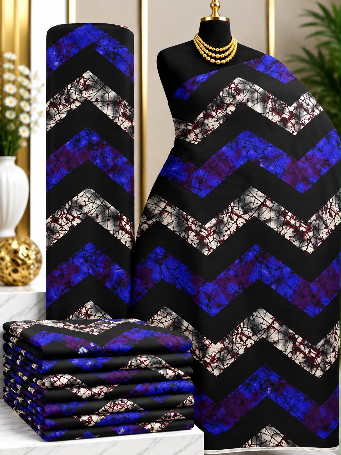 Violet Chevron African print cotton fabric in blue, purple, black and gray, featuring broad zigzag bands with contrasting mottled sections; shown draped and folded.