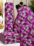 Orchid Petals African print cotton fabric in pink, purple, cream and green, featuring large rounded floral shapes and fine ornamental details; shown draped and folded.