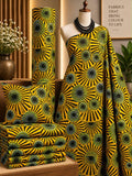 Golden Radiance African print cotton fabric in yellow, green and black, featuring radiating sunburst-like circles; shown draped and folded.