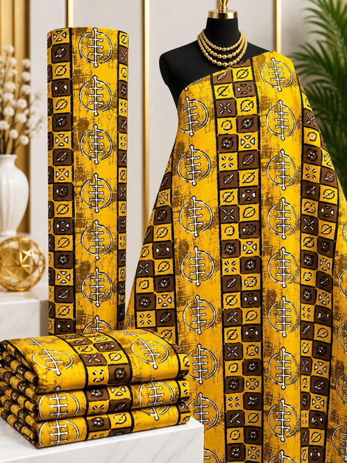 Amber Tilework African print cotton fabric in yellow, brown and cream, featuring alternating squares with ornamental geometric details; shown draped and folded.