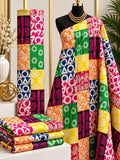 Rainbow Quilt African print cotton fabric in pink, yellow, green, blue and white, featuring bright patchwork squares filled with ornamental motifs; shown draped and folded.