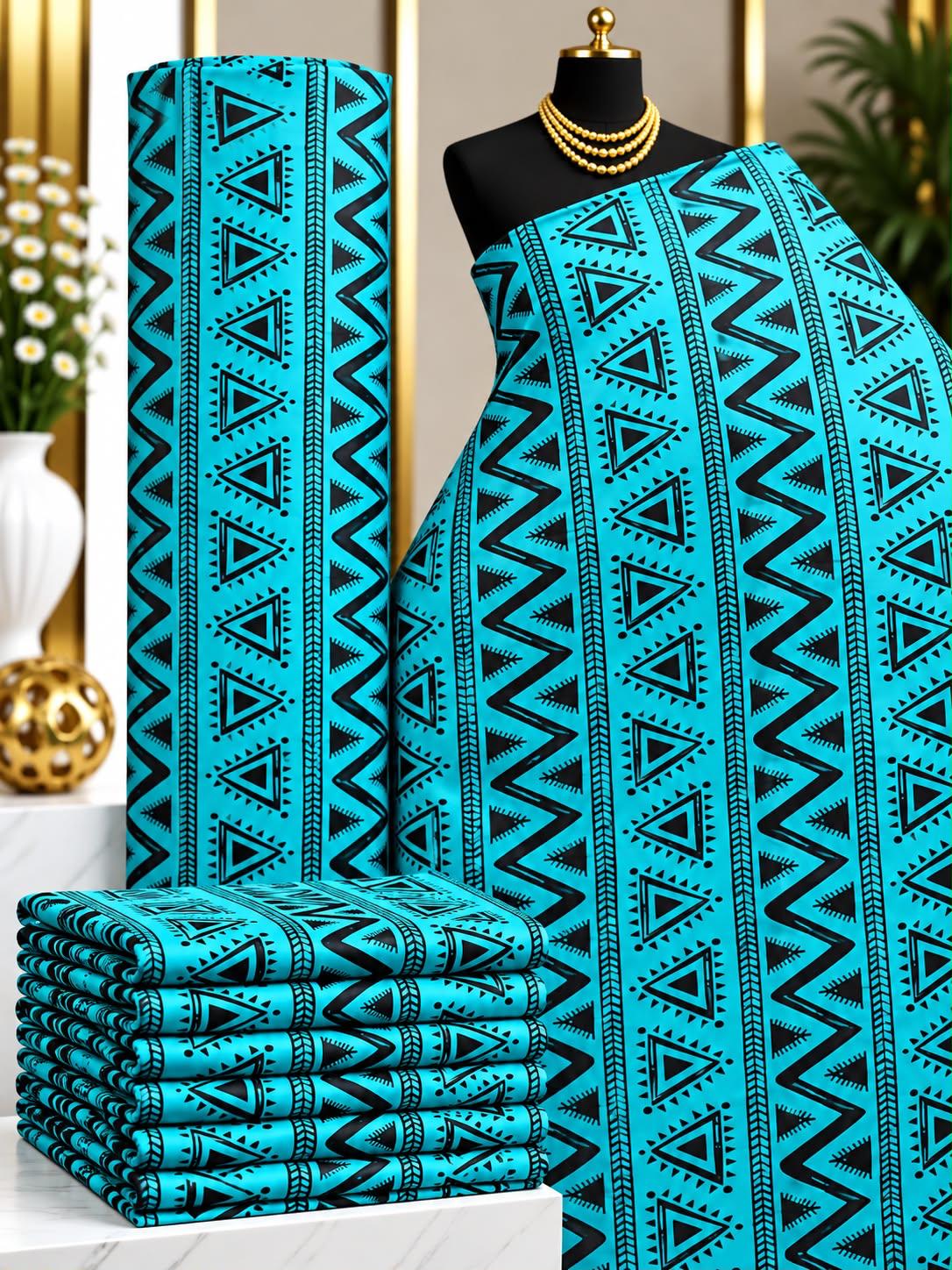 Lagoon Angles African print cotton fabric in turquoise and black, featuring vertical rows of triangles and zigzag details; shown draped and folded.