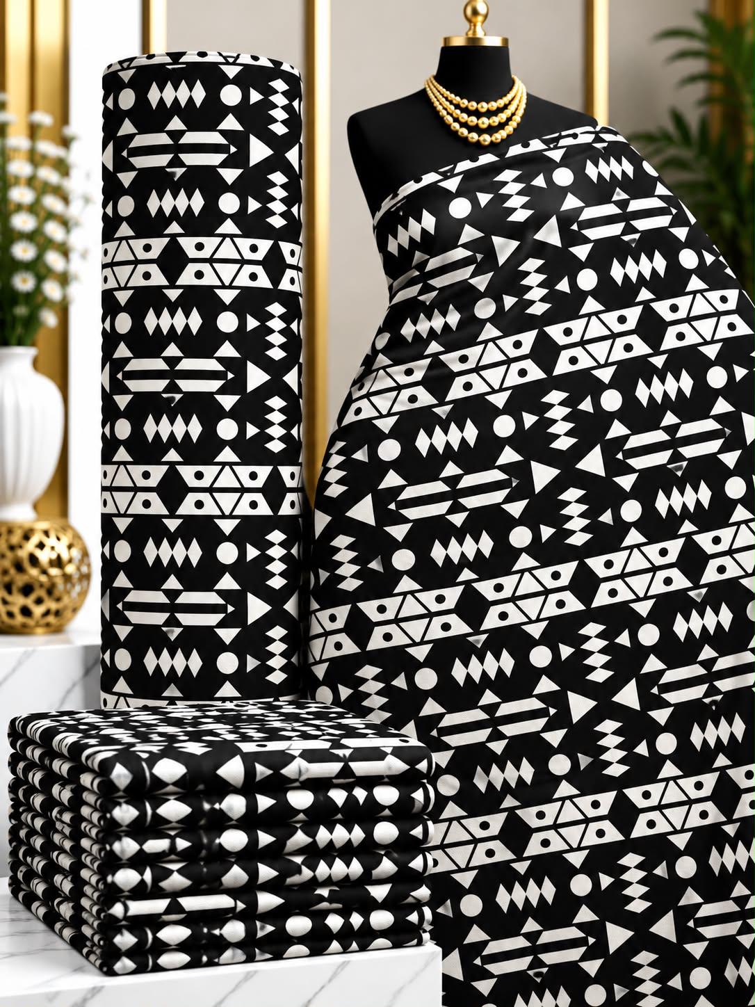 Midnight Notation African print cotton fabric in black and white, featuring horizontal rows of small geometric and abstract marks; shown draped and folded.