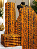 Amber Rhythm African print cotton fabric in orange, yellow and black, featuring narrow vertical bands of repeated geometric details; shown draped and folded.