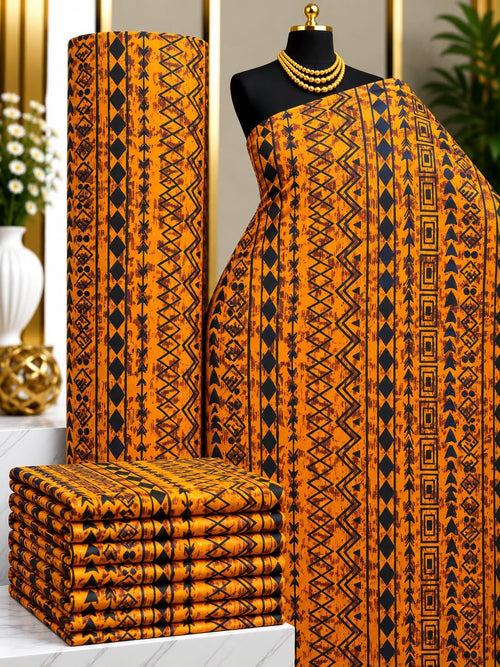 Amber Rhythm African print cotton fabric in orange, yellow and black, featuring narrow vertical bands of repeated geometric details; shown draped and folded.