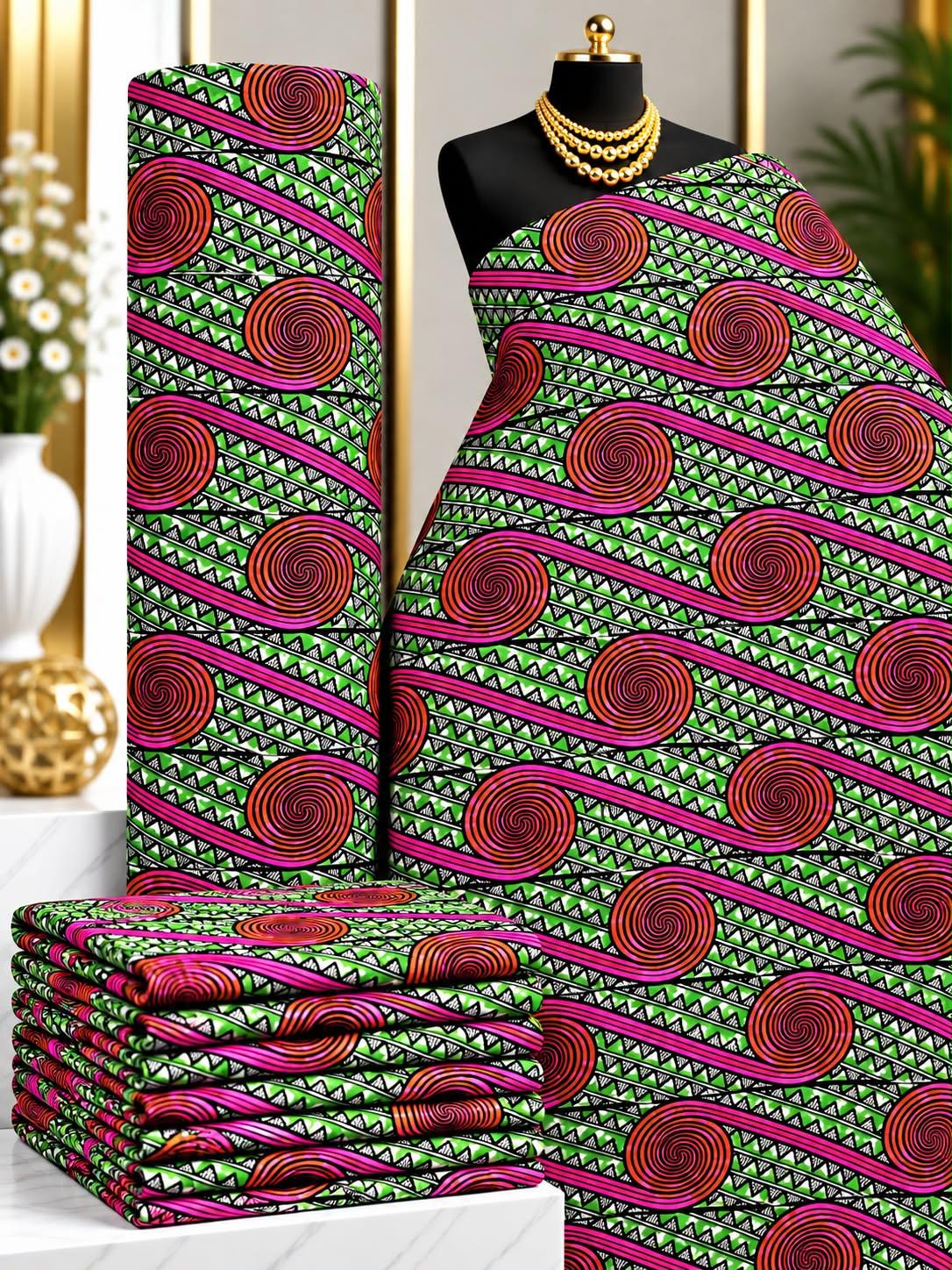 Jade Rosettes African print cotton fabric in green, pink and black, featuring diagonal rows of circular ornamental medallions; shown draped and folded.